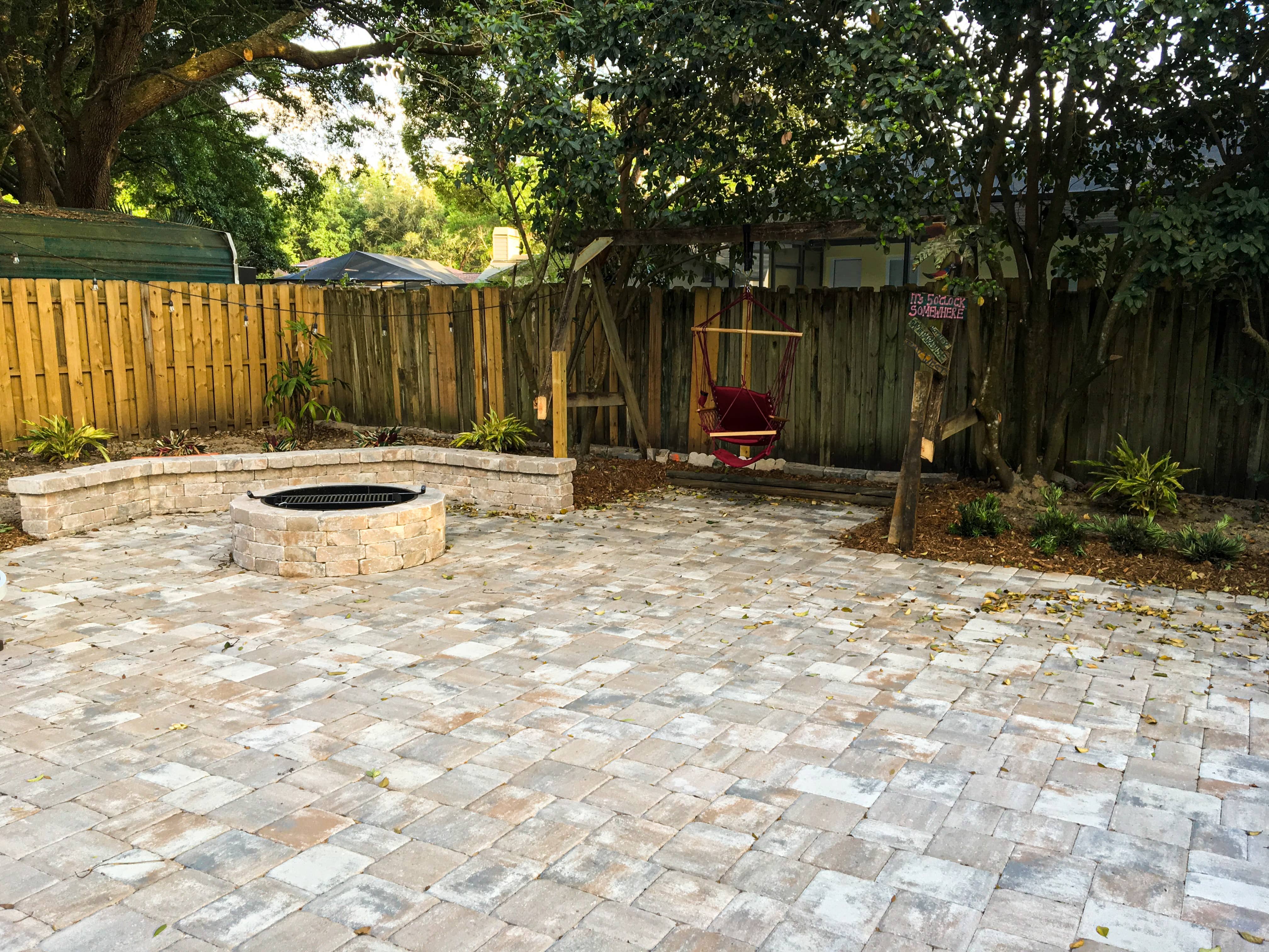stone patio with fire pit and gardens