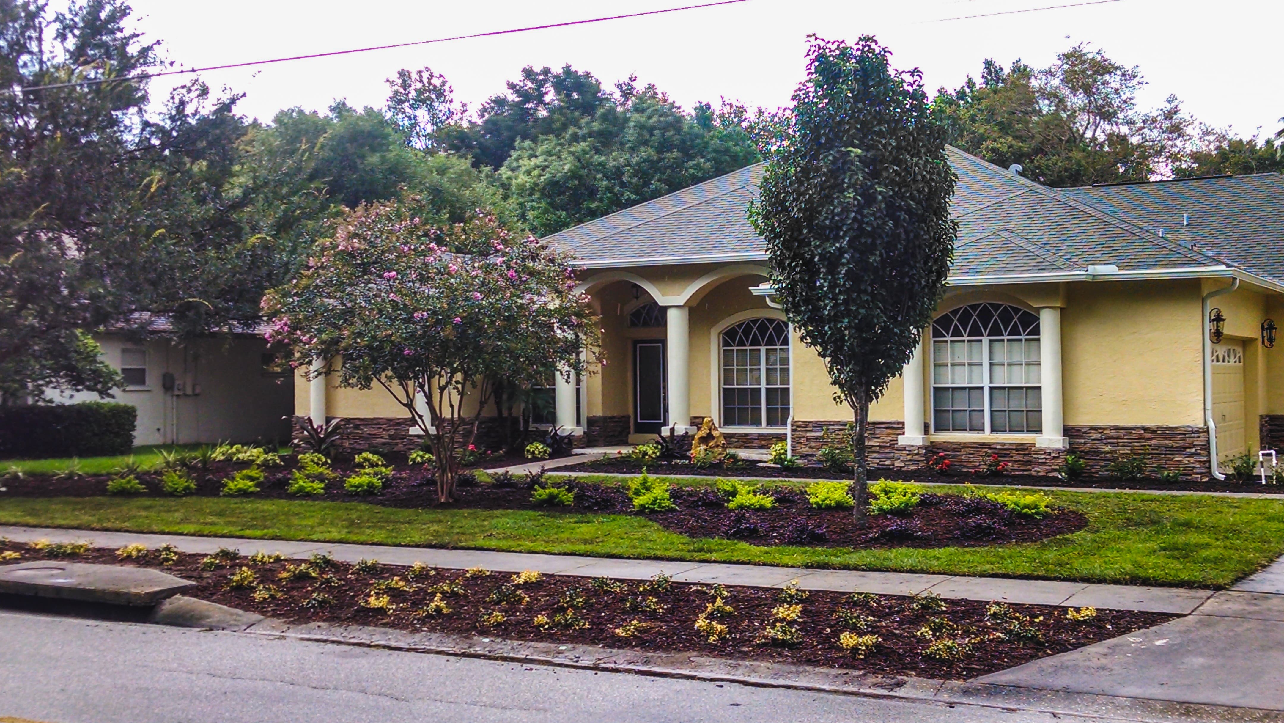 front yard landscape with crepe myrtle trees, and garden beds for curb appeal